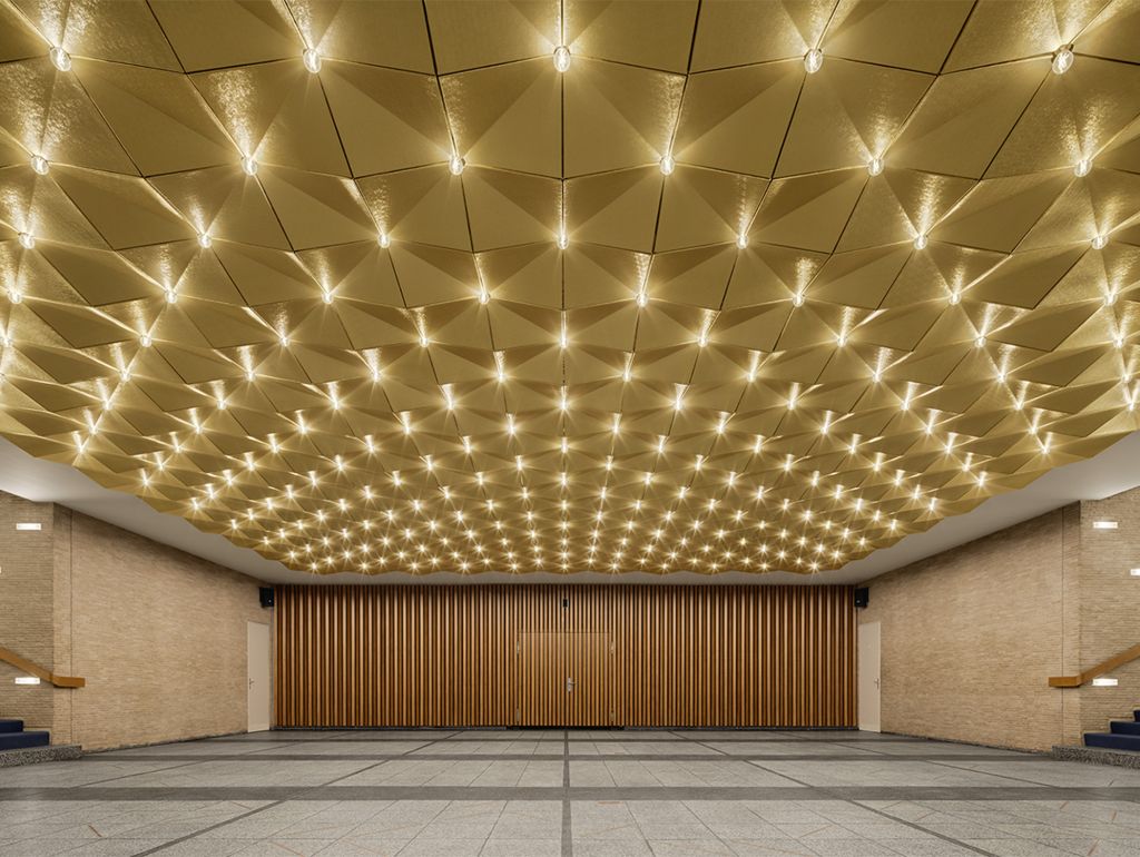 Die restaurierte ‚Golddecke‘ im Eingangsbereich sowie die Treppenhalle mit freigelegtem Mauerwerk